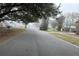 Street view with an overcast sky in a neighborhood with mature landscaping and charming homes at 8203 Bluestar Cir, Orlando, FL 32819