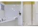 Bright bathroom featuring a soaking tub and a glass-enclosed shower at 9051 Treasure Trove Ln # 505, Kissimmee, FL 34747