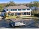 Expansive aerial view of a modern lakefront property featuring a boat dock and backyard pool with lovely landscaping at 9138 Bay Point Dr, Orlando, FL 32819