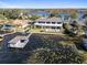 Aerial view of a waterfront home with a private pool and boat dock on a serene lake at 9138 Bay Point Dr, Orlando, FL 32819