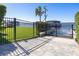 Wrought iron gate leading to a private dock with a boat house on the lake, with lovely landscaping at 9138 Bay Point Dr, Orlando, FL 32819