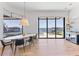 Modern dining room with hardwood floors, a unique chandelier, and a beautiful view of the water at 9138 Bay Point Dr, Orlando, FL 32819