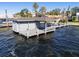 Boat dock on a lake with a shaded area and boat lift at 9138 Bay Point Dr, Orlando, FL 32819