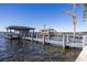 Private boat dock featuring boat house and boat lift, offering direct access to the lake at 9138 Bay Point Dr, Orlando, FL 32819