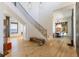 Bright foyer with grand staircase, wood floors, and contemporary decor offering a sophisticated and welcoming entrance at 9138 Bay Point Dr, Orlando, FL 32819