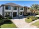 Stunning two-story home with a well-manicured lawn and a spacious paved driveway at 9138 Bay Point Dr, Orlando, FL 32819