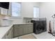 Well-lit laundry room with modern washer and dryer, countertops, and storage cabinets at 9138 Bay Point Dr, Orlando, FL 32819