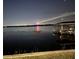 Waterfront view showing a covered dock and fireworks reflecting over the lake at night at 9138 Bay Point Dr, Orlando, FL 32819