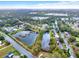 Aerial view of the neighborhood showcasing lakes and lush green landscapes at 105 Norris Pl, Casselberry, FL 32707