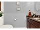 Close-up of a powder room sink with dark wood cabinetry and granite countertops at 105 Norris Pl, Casselberry, FL 32707