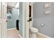 View into a half bathroom and laundry room featuring light tiled flooring and gray walls at 105 Norris Pl, Casselberry, FL 32707