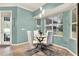 Bright breakfast nook with a round glass table, white chairs, and natural light from large windows at 105 Norris Pl, Casselberry, FL 32707