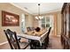 An inviting dining room featuring a chandelier, an elegant dining table, and ample natural light at 105 Norris Pl, Casselberry, FL 32707