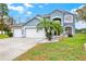 Welcoming two-story house with a large driveway, three-car garage, and well-kept lawn at 105 Norris Pl, Casselberry, FL 32707