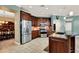 Stylish kitchen with dark cabinetry, stainless steel appliances, and an adjacent dining area at 105 Norris Pl, Casselberry, FL 32707