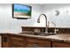 Close up of kitchen sink and countertop featuring dark cabinets and granite at 105 Norris Pl, Casselberry, FL 32707