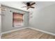 This bedroom includes wood-look tile flooring, a window with blinds, a ceiling fan and modern accents at 1080 Abell Cir, Oviedo, FL 32765