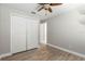 This bedroom has wood-look tile flooring, a double door closet, and is freshly painted, clean and move in ready at 1080 Abell Cir, Oviedo, FL 32765