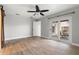 A spacious bedroom with wood-look tile flooring, a ceiling fan, and a sliding glass door to the patio at 1080 Abell Cir, Oviedo, FL 32765