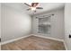 Bright bedroom featuring wood-look tile flooring, a window with blinds, and a ceiling fan at 1080 Abell Cir, Oviedo, FL 32765