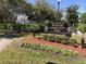 Alafaya Woods Community Park sign surrounded by colorful flowers and manicured landscaping on a sunny day at 1080 Abell Cir, Oviedo, FL 32765