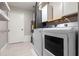 Bright laundry room with modern washer and dryer, added shelving and storage at 1080 Abell Cir, Oviedo, FL 32765