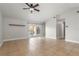 Bright, airy living room with tile flooring, vaulted ceilings, and sliding glass doors to the yard at 1080 Abell Cir, Oviedo, FL 32765