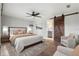 Stylishly furnished main bedroom featuring a decorative rug, barn door, and adjacent ensuite bathroom at 1080 Abell Cir, Oviedo, FL 32765