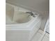 Close-up of a white tiled bathtub with a chrome faucet at 10800 Cherry Oak Cir, Orlando, FL 32817