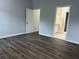 A spacious bedroom with luxury vinyl plank flooring and an en-suite bathroom at 10800 Cherry Oak Cir, Orlando, FL 32817