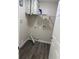 This laundry room features modern vinyl plank flooring and a storage shelf at 10800 Cherry Oak Cir, Orlando, FL 32817
