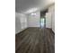 A well-lit room featuring luxury vinyl plank flooring and a modern light fixture at 10800 Cherry Oak Cir, Orlando, FL 32817