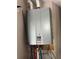 A close-up of a Rinnai tankless water heater, showcasing modern efficiency for the home at 10800 Cherry Oak Cir, Orlando, FL 32817