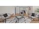 Upstairs bonus room with wood floors, modern chairs, game table, and bright walls at 12621 Oulton Cir, Orlando, FL 32832