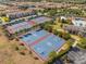Aerial view showcases tennis and basketball courts, surrounded by trees and lush landscaping and a view of the community pool at 12621 Oulton Cir, Orlando, FL 32832