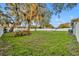 View of a large, fenced backyard featuring mature trees and lush greenery at 1416 E 20Th St, Sanford, FL 32771