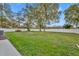 Large grassy backyard enclosed by a white privacy fence and shaded by mature oak trees at 1416 E 20Th St, Sanford, FL 32771
