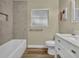 Well lit bathroom with combination tub and shower, window, toilet, and a vanity with storage at 1416 E 20Th St, Sanford, FL 32771