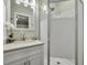 Bathroom boasts a glass door shower, vanity with storage, white cabinets, and decorative flower at 1416 E 20Th St, Sanford, FL 32771