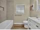 Bathroom featuring a bathtub, white vanity, and wood look flooring at 1416 E 20Th St, Sanford, FL 32771