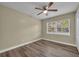 A bedroom with wood floor, neutral walls, and a large window that provides a clear outside view at 1416 E 20Th St, Sanford, FL 32771