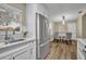 Kitchen featuring stainless steel refrigerator, white cabinetry, and a view of the dining area at 1416 E 20Th St, Sanford, FL 32771