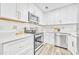 Modern kitchen with stainless steel appliances, white cabinets, and light-colored countertops at 1416 E 20Th St, Sanford, FL 32771