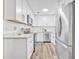 Bright kitchen with white cabinets, stainless steel appliances, and wood-look floors at 1416 E 20Th St, Sanford, FL 32771