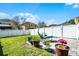 A backyard features a paver patio, green grass, and a white fence at 14554 Black Cherry Trl, Winter Garden, FL 34787