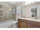 This bathroom features double sinks, a shower-tub combo, and great natural light at 14554 Black Cherry Trl, Winter Garden, FL 34787