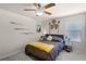 A simple bedroom with a ceiling fan, neutral colors, and a closet at 14554 Black Cherry Trl, Winter Garden, FL 34787