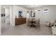 Cozy dining area with elegant wood accents, neutral tones, and tiled floors at 14554 Black Cherry Trl, Winter Garden, FL 34787