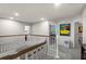 Upstairs hallway with wood-trimmed railing and neutral tones at 14554 Black Cherry Trl, Winter Garden, FL 34787