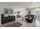 Spacious living room featuring tile floors, a ceiling fan, and a plush brown sectional sofa at 14554 Black Cherry Trl, Winter Garden, FL 34787